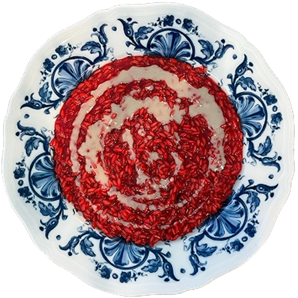 Risotto al melograno con fonduta di gorgonzola, piatto del ristorante Da Alcide a Venturina, in Toscana.